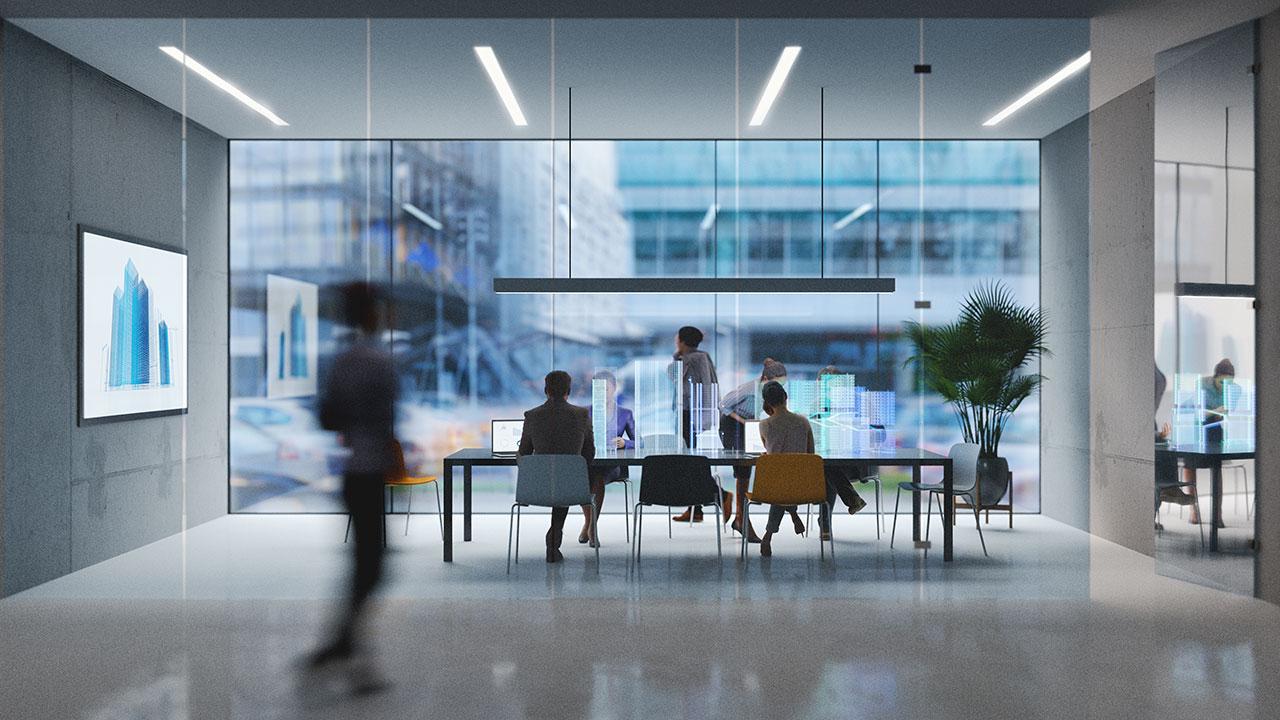 A photo of employees walking, sitting, and working in a Tetra Tech office space with large glass windows